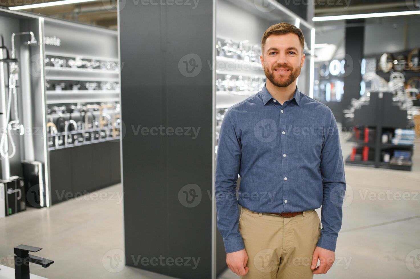 Portrait of salesperson in bathroom store. Happy man works in bath store. Sales occupation photo