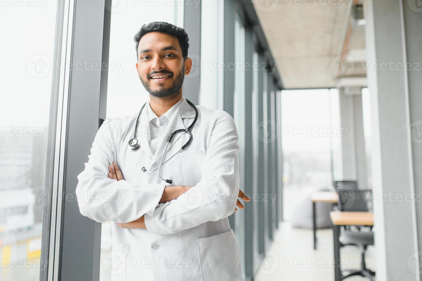 medicine, healthcare and people concept - happy male doctor with stethoscope and clipboard at clinic photo