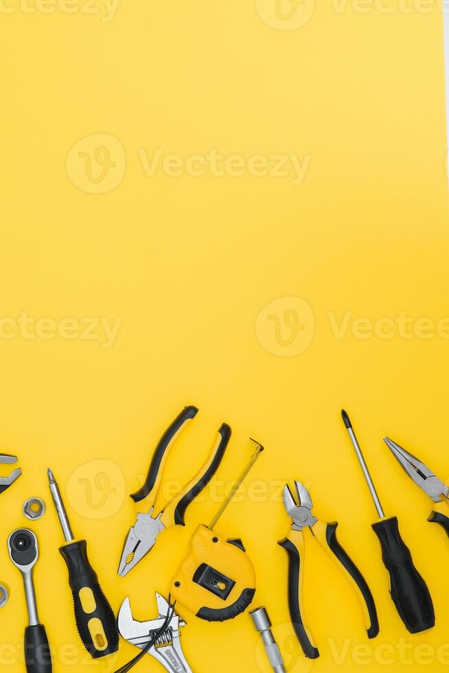 Set of various construction tools. Tools for home repair. Work at a construction site. On a yellow background. Flatly. Flatlay. photo