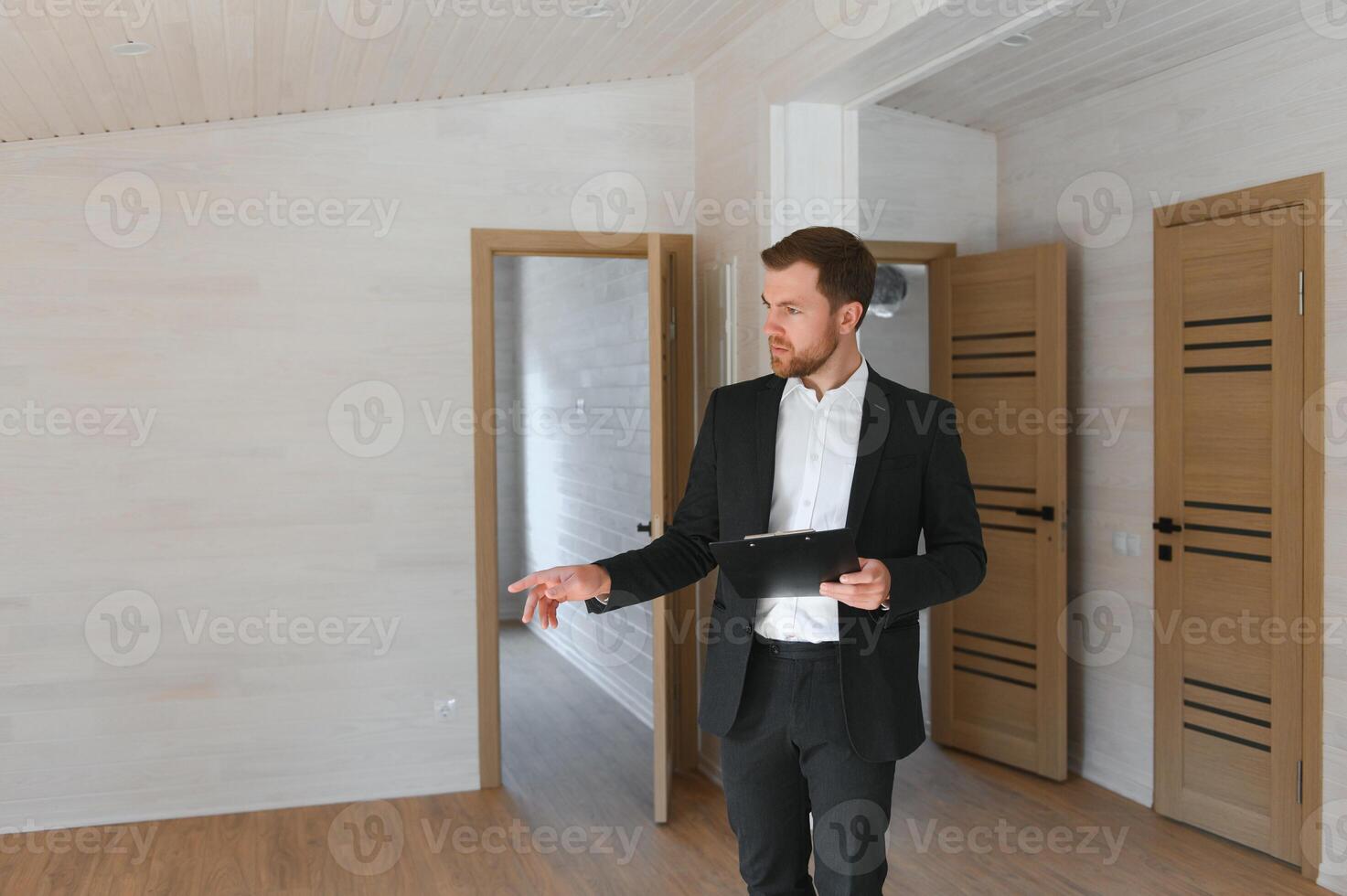 Cheerful real estate agent in new apartment photo