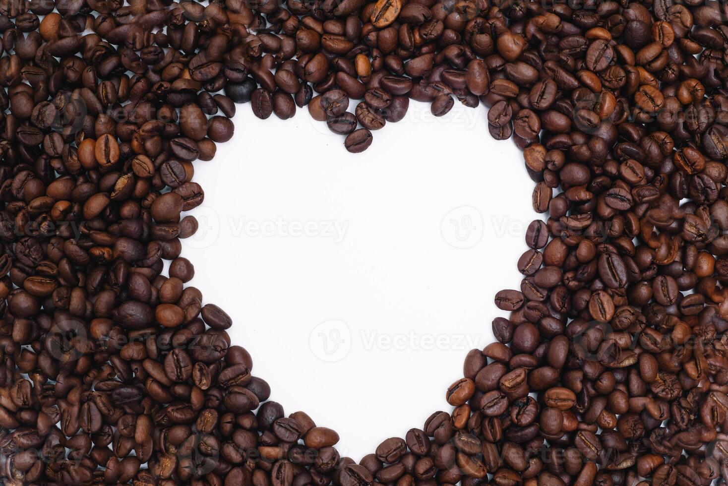 Coffee beans in heart shape white background isolated photo