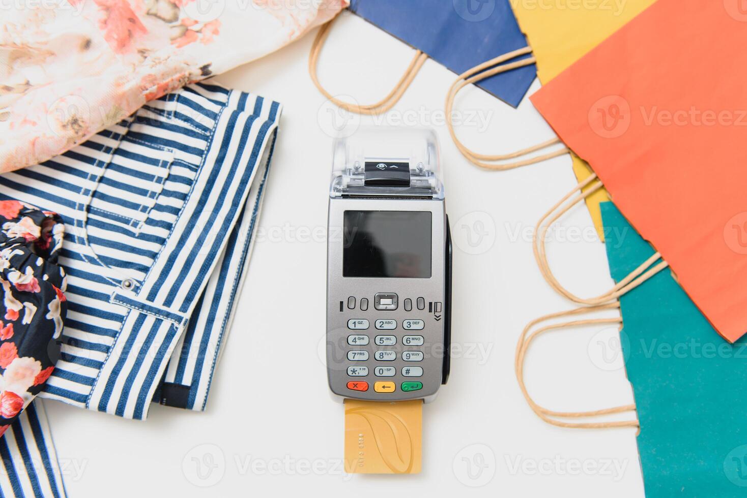 Close up of hand using credit card swiping machine to pay. credit card payment through a shopping terminal. Credit card payment for new clothing collection photo