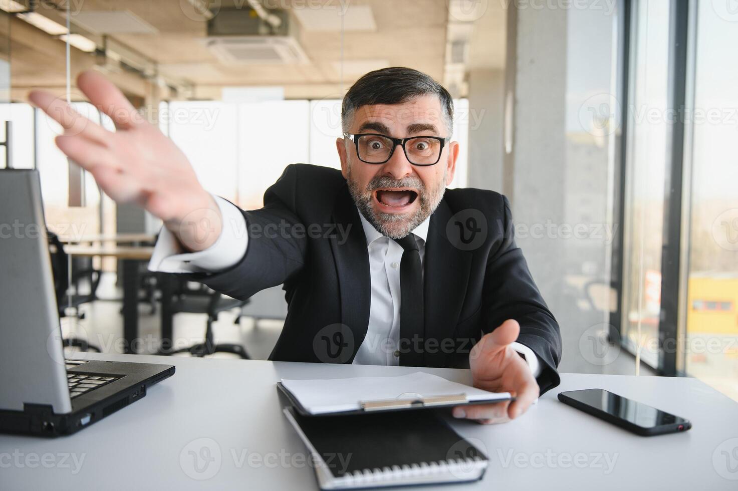 Angry businessman with document shouting at somebody photo