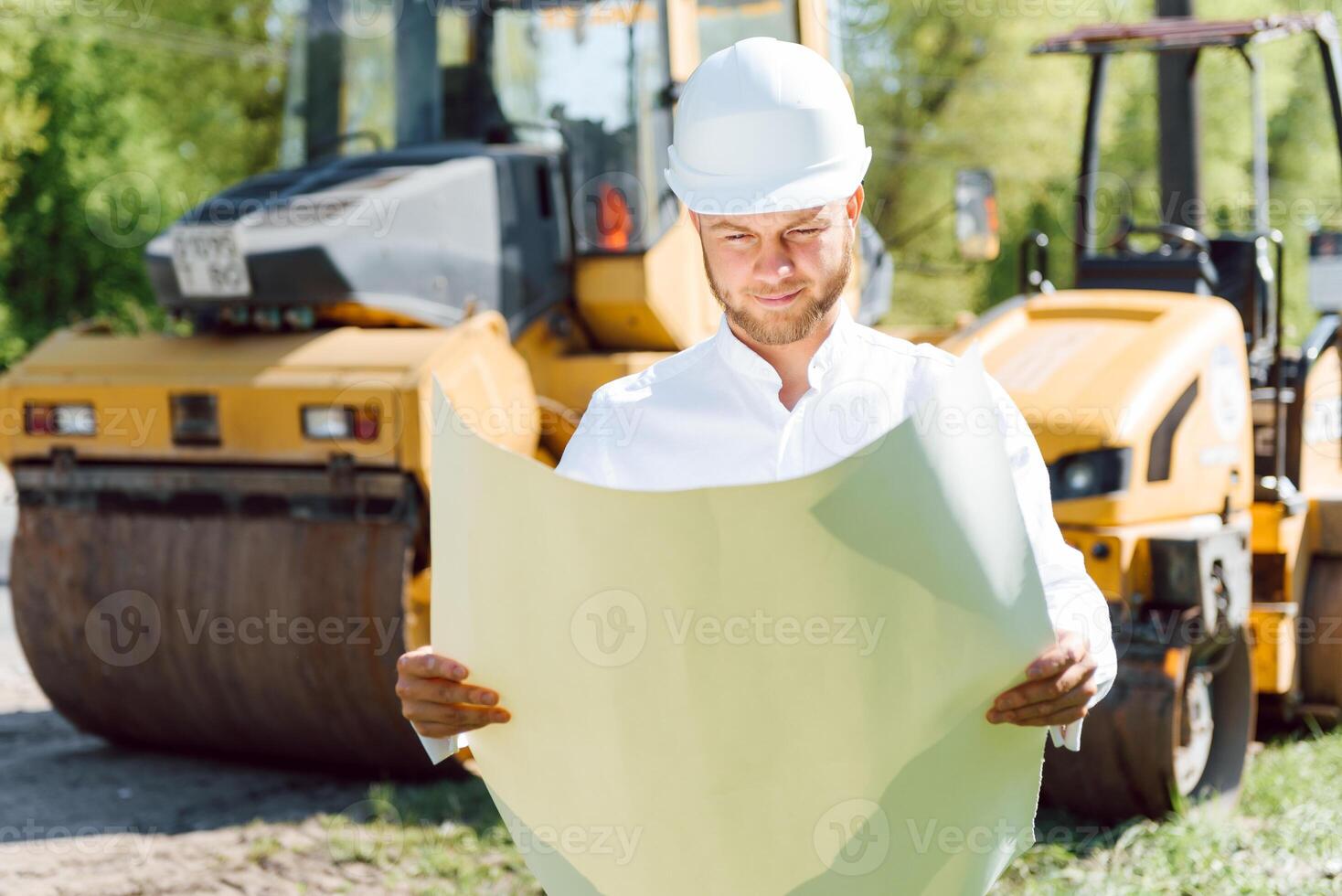 engineer near road machinery. The concept of building a new asphalt road. Road repair. Road service worker near the rink. photo