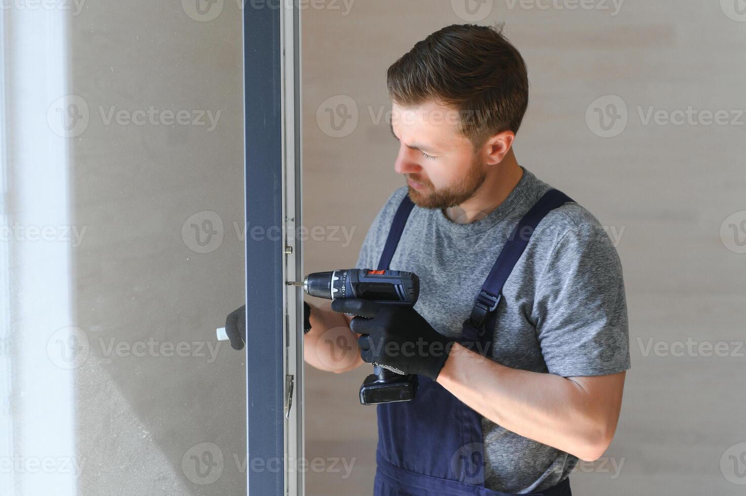 A worker installs windows in a new modular home. The concept of a new home. photo