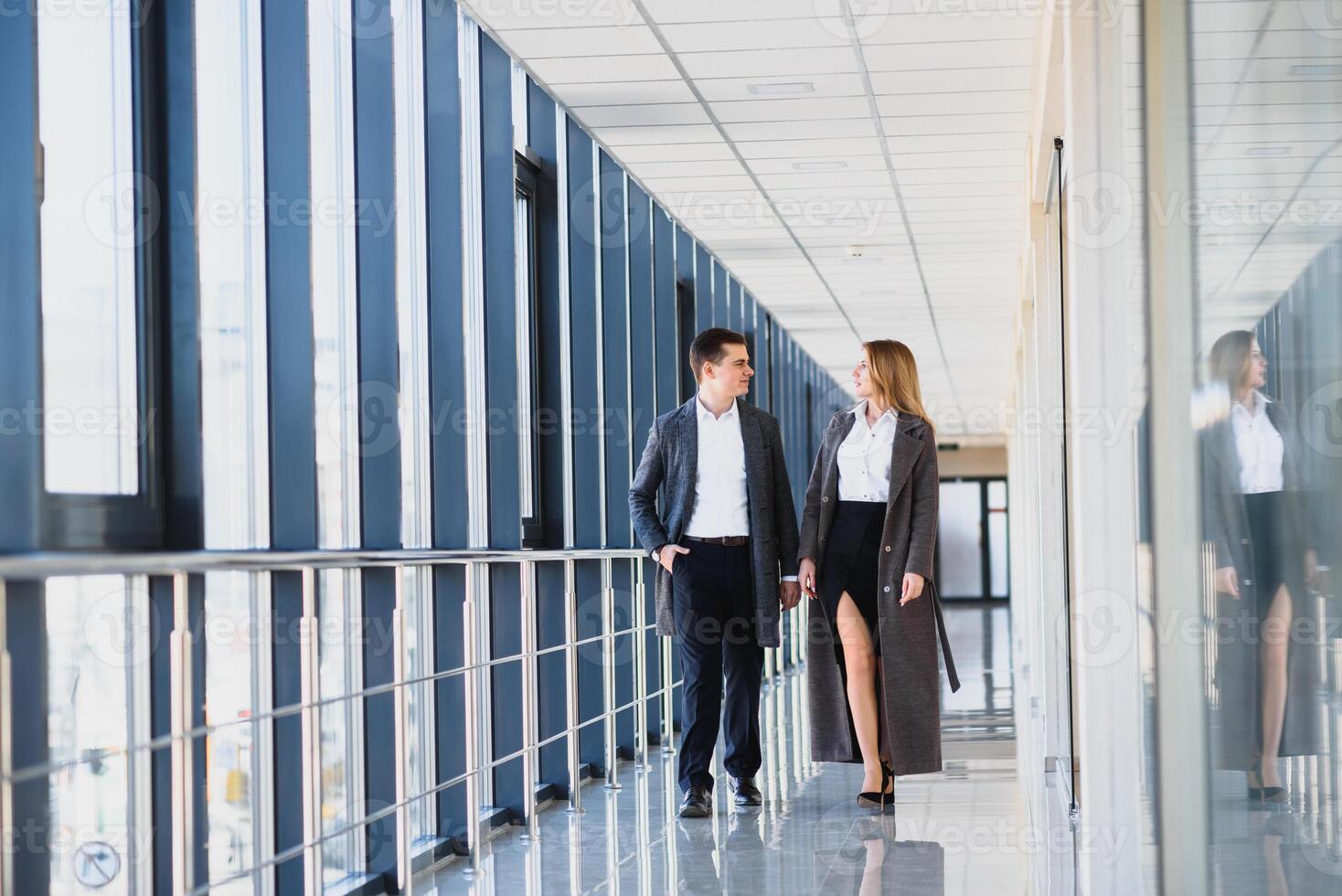 The business people walk in the office hall photo