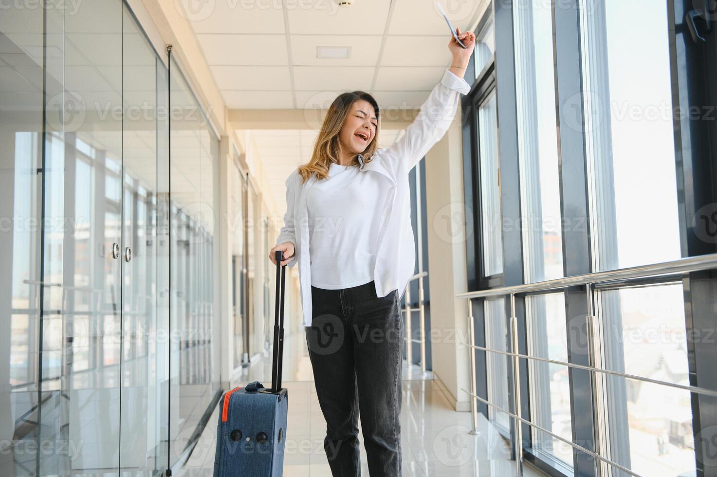 Happy woman traveling and walking in airport photo