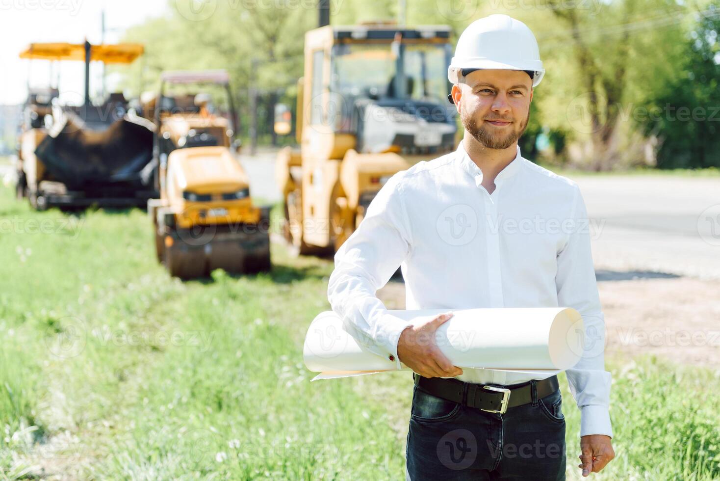 engineer near road machinery. The concept of building a new asphalt road. Road repair. Road service worker near the rink. photo