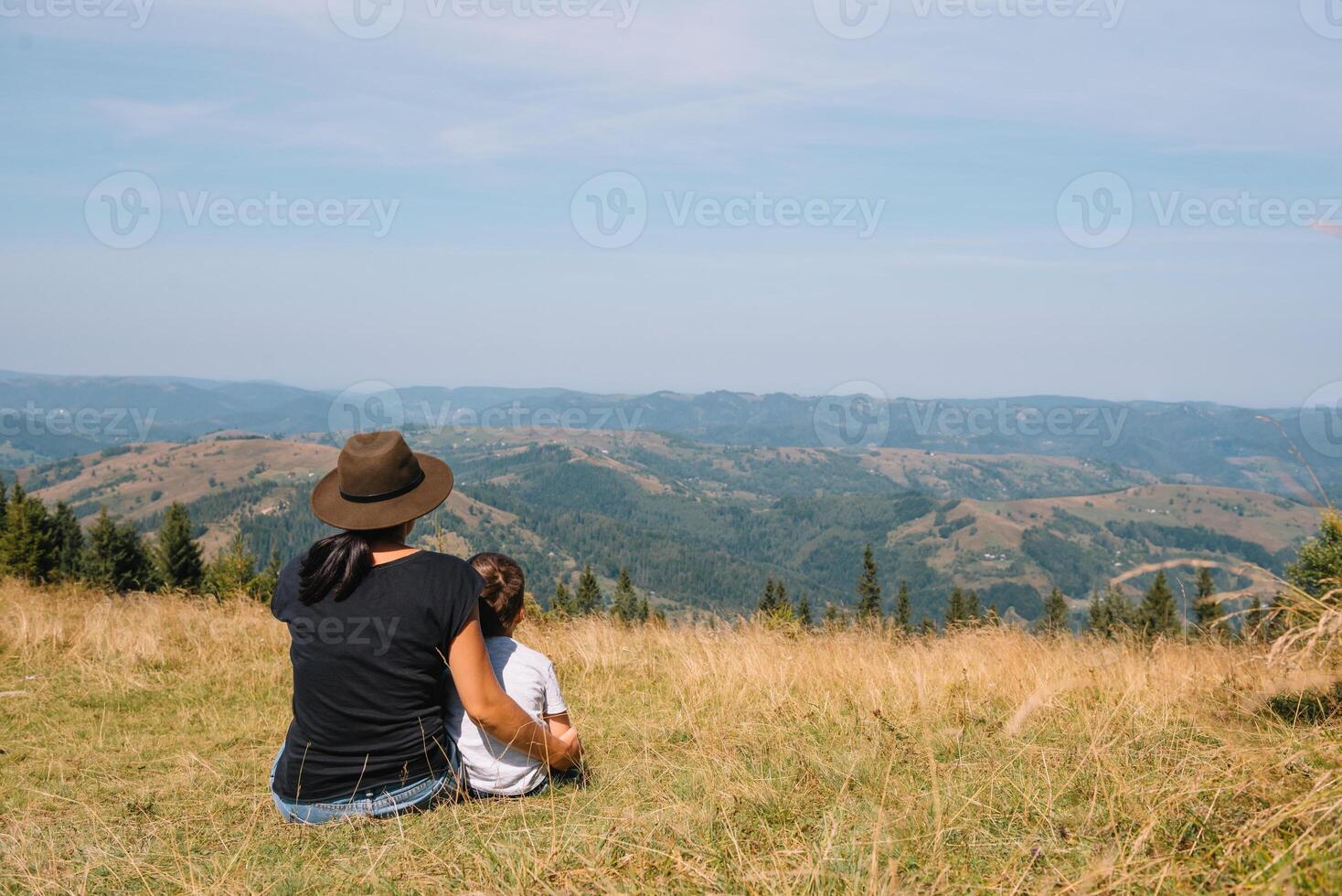mother and son having rest on vacation in mountains photo