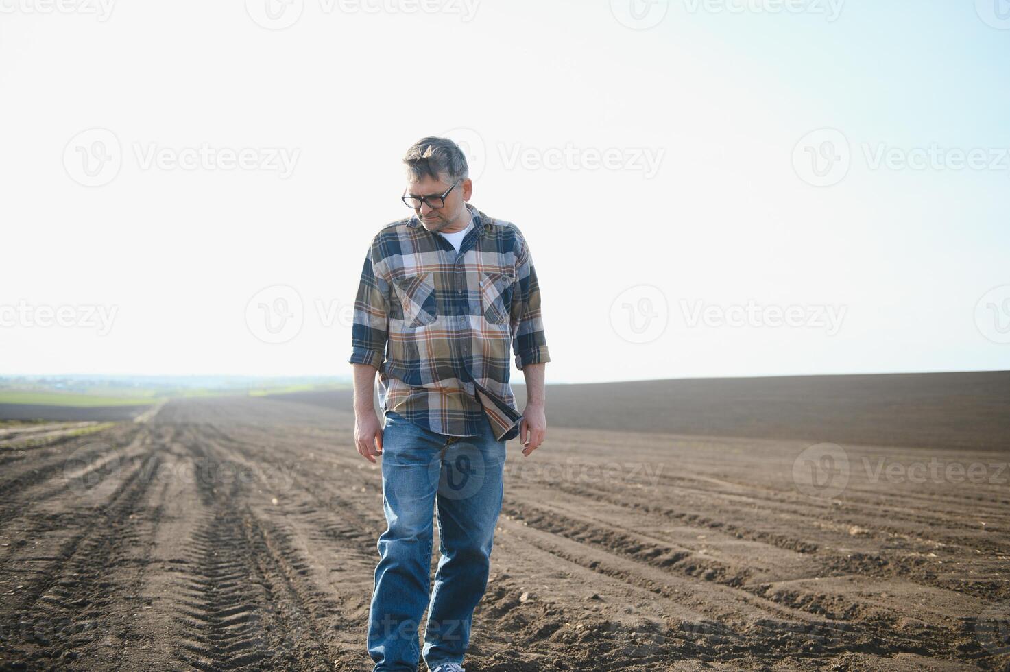 A farmer checks quality of soil before sowing. photo