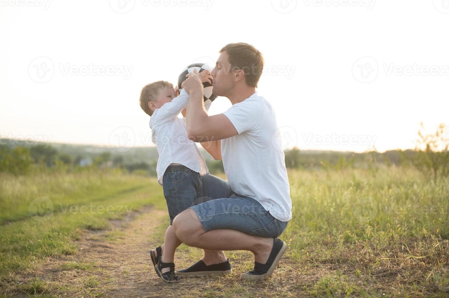 father's day. Dad and son playing together outdoors on a summer. Happy family, father, son at sunset. photo