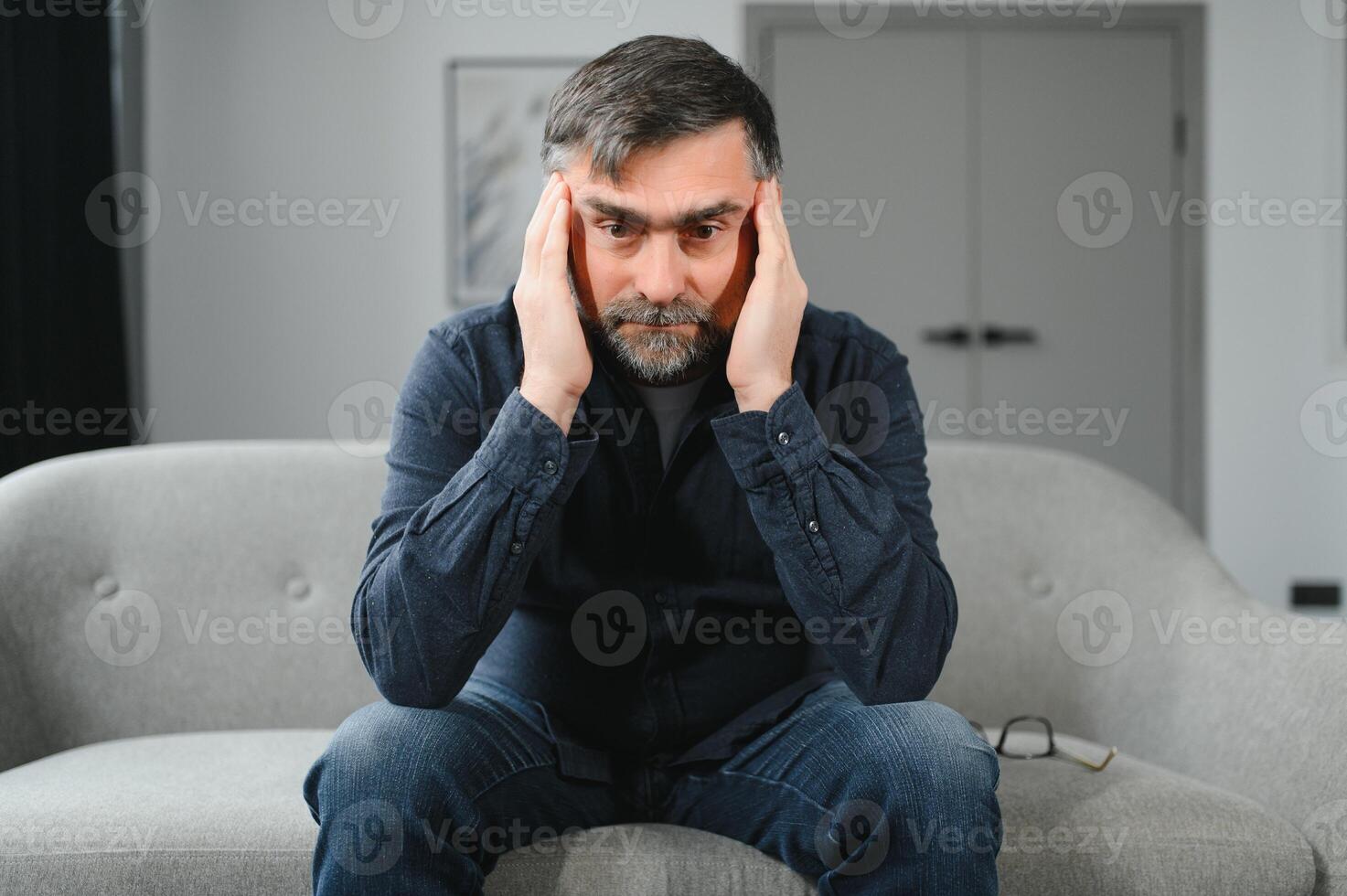 Headache. Senior Man Suffering From Migraine Pain Massaging Temples Sitting At Home. Healthcare, Health Problems In Older Age Concept photo