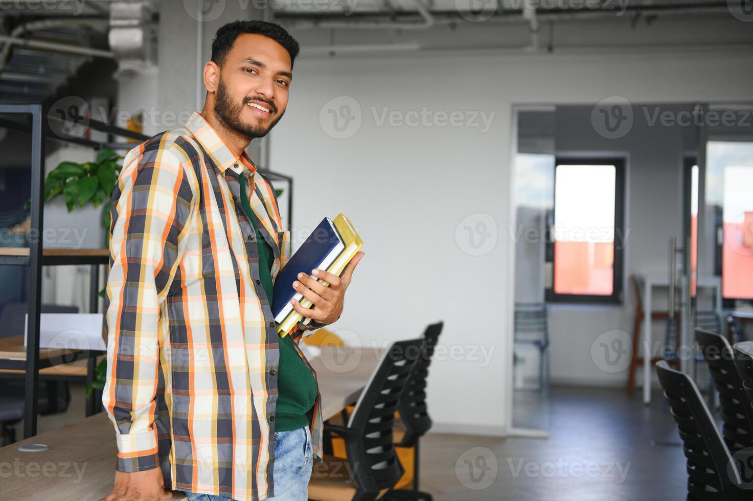 Happy indian male student at the university photo