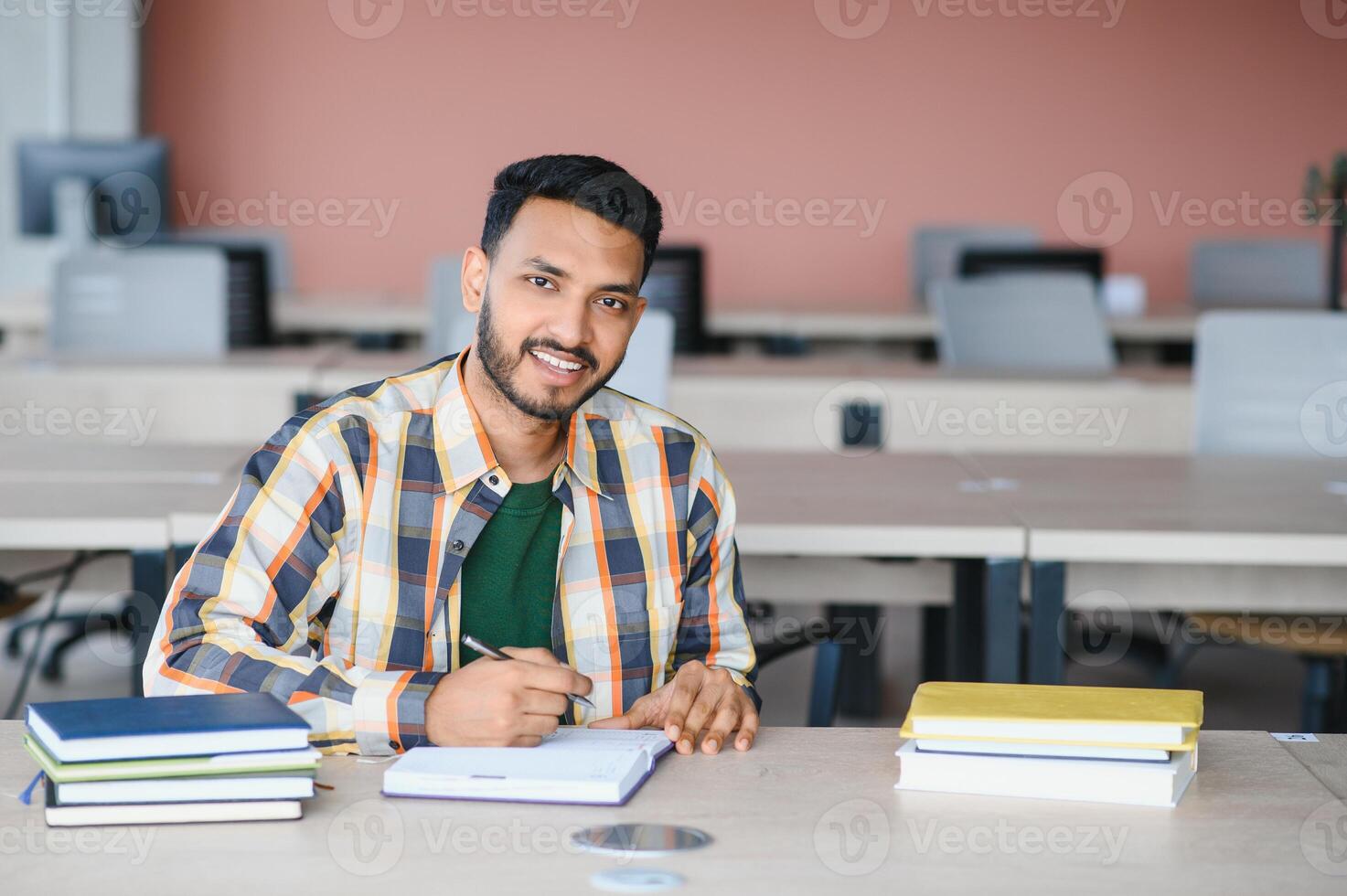 Happy indian male student at the university photo