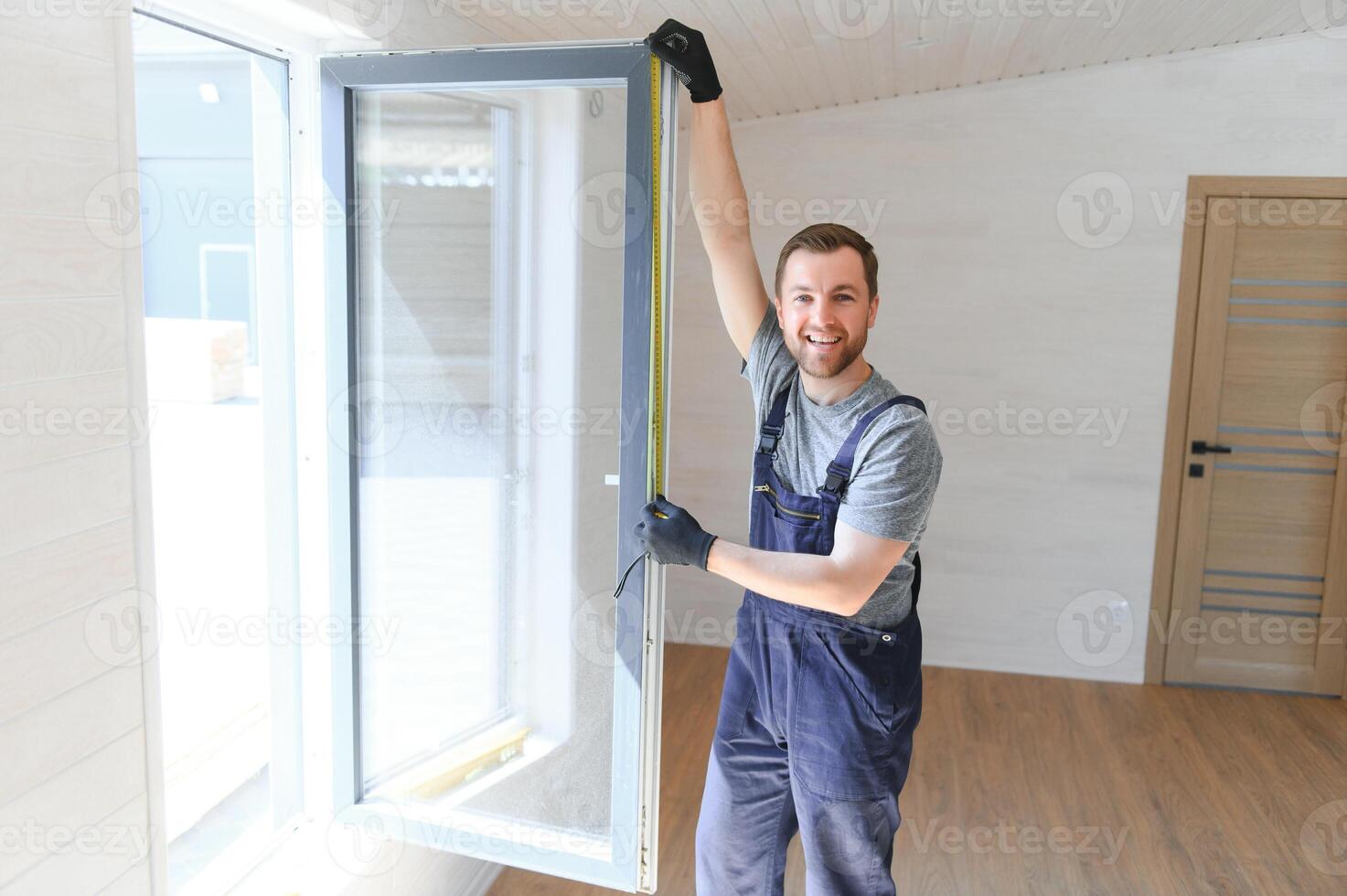 The worker installing and checking window in the house. Concept of new modular houses. photo