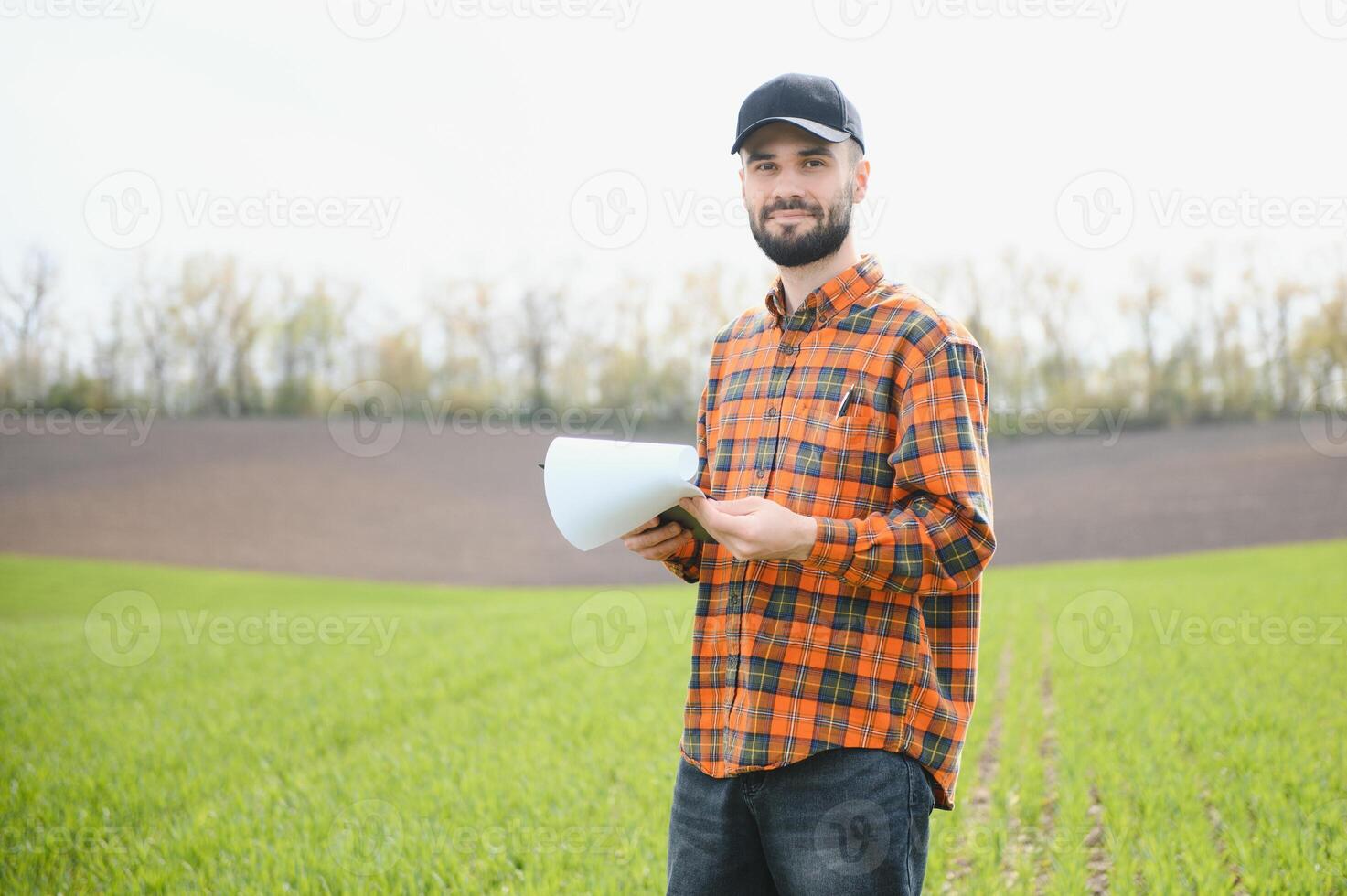 Portrait of farmer standing in field. photo