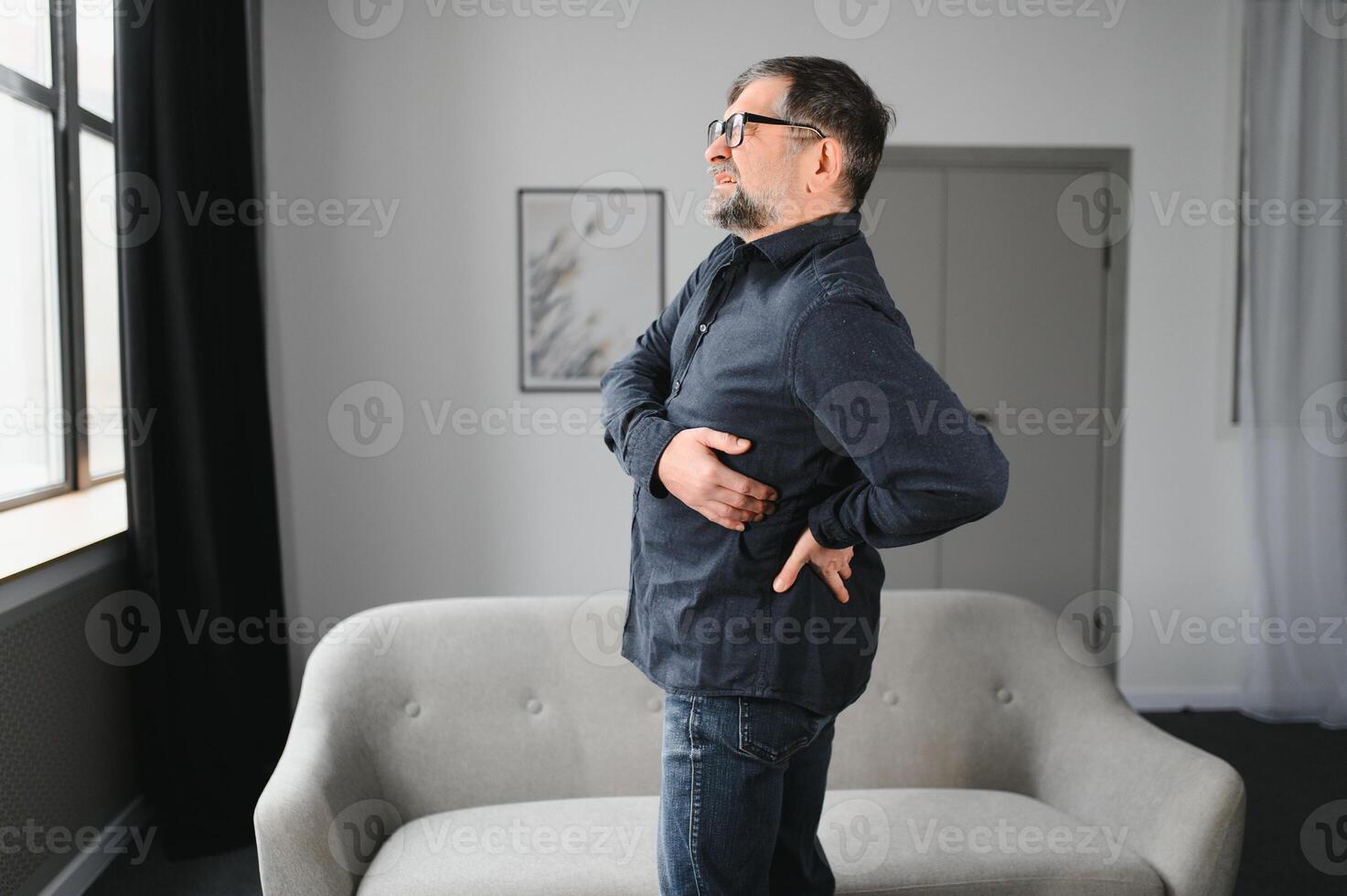 Senior man with back pain. Mature man suffering from low back pain. Old man with back pain photo