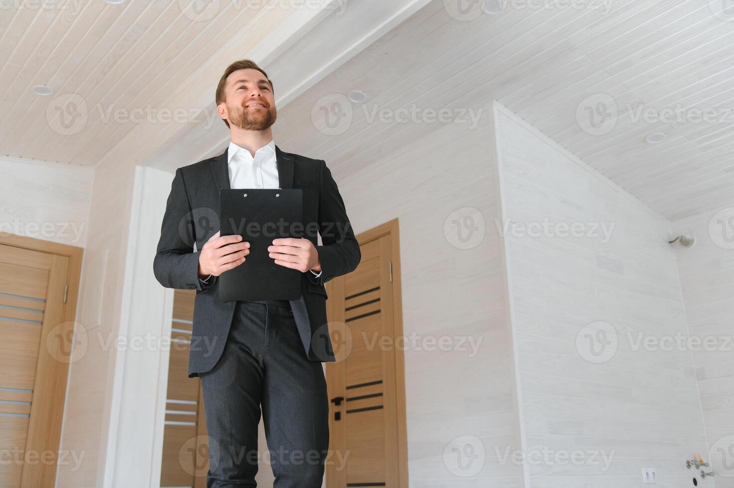 Closeup portrait of a confident male estate agent smiling photo
