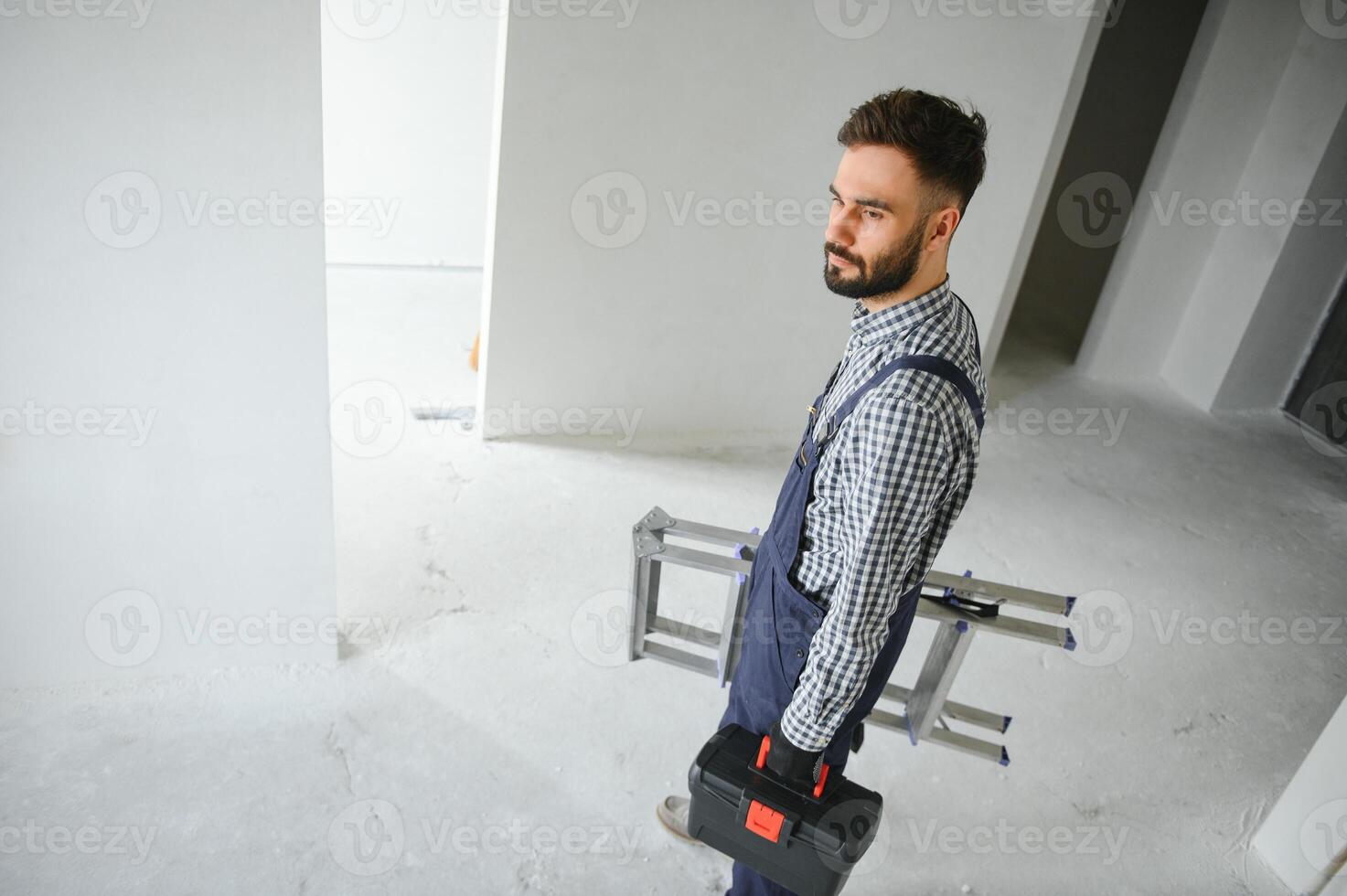 Young worker making repair in room photo