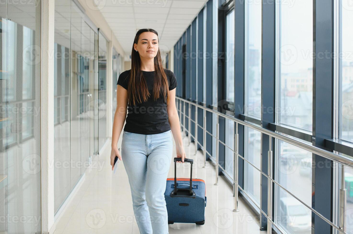 pretty woman waiting for her flight at airport photo