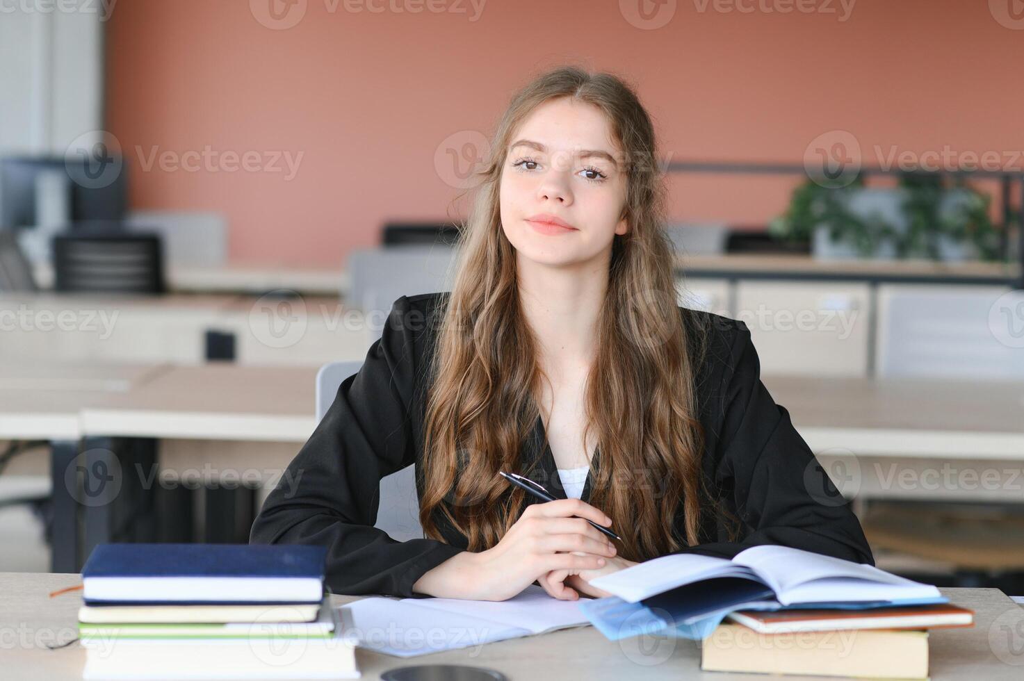 adolescente niña estudiando con libro de texto escritura ensayo aprendizaje en aula. foto