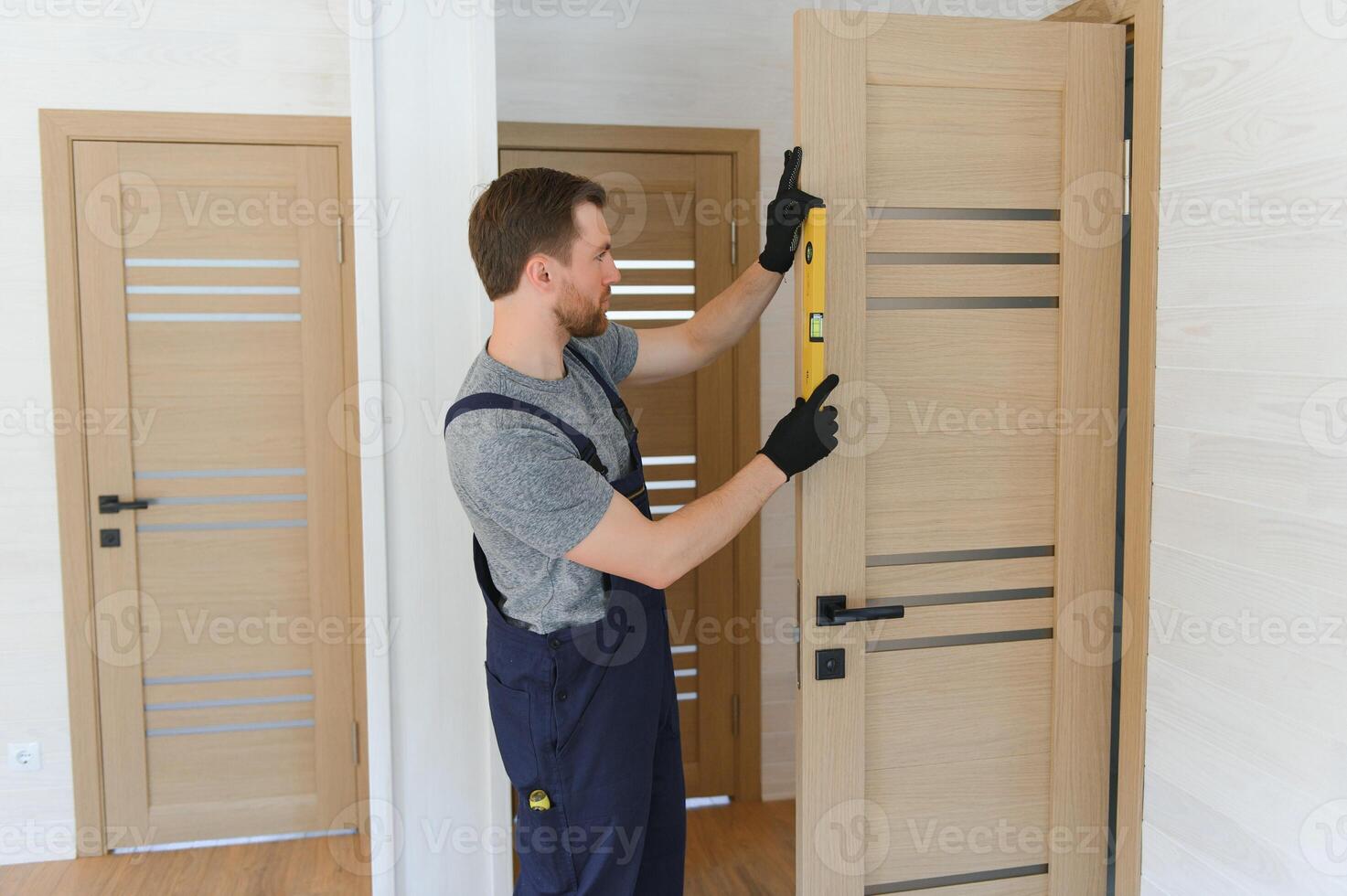 Young man fixing the door in house photo