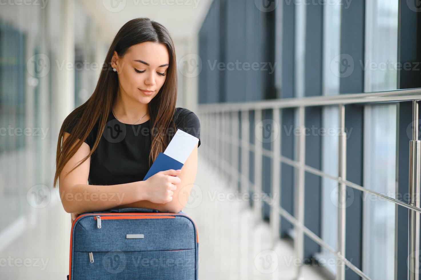 pretty woman waiting for her flight at airport photo