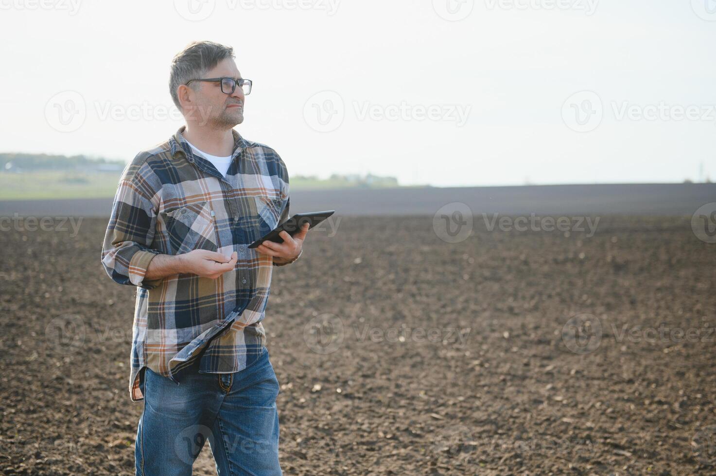 A farmer checks quality of soil before sowing. photo