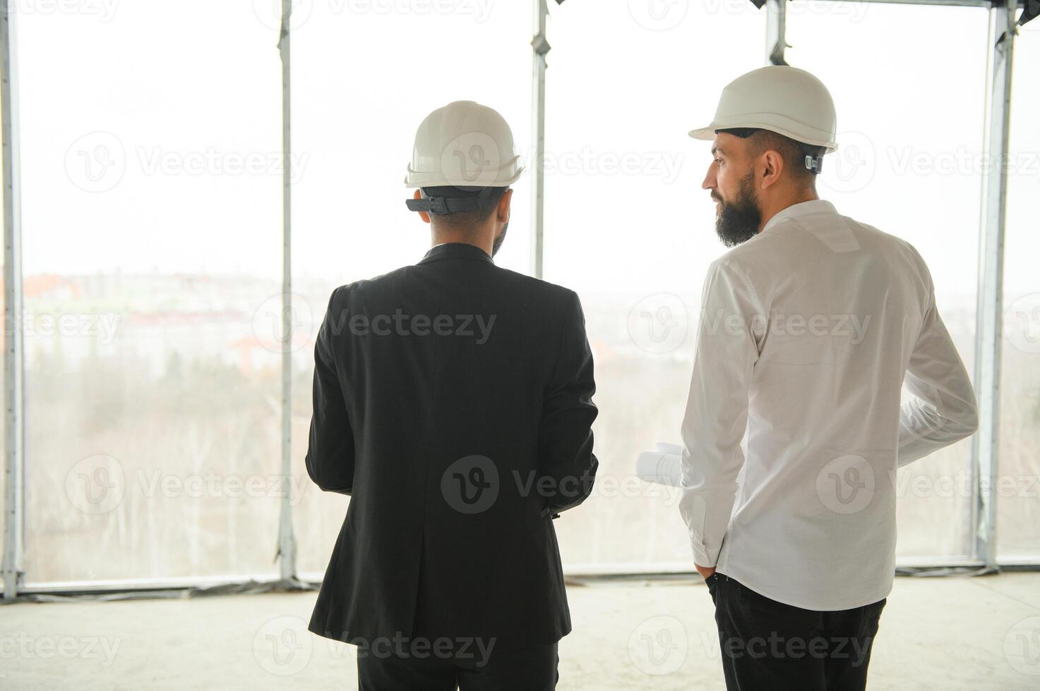 Construction concept of multiracial Engineer and Architect working at Construction Site with blue print photo