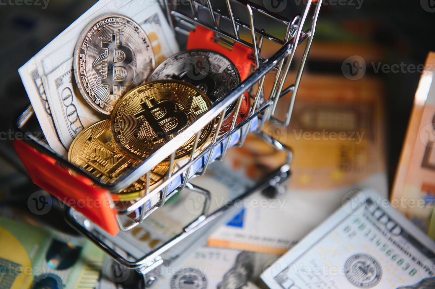 Close up heap of golden bitcoin physical coins on top of Euro, dollar banknotes background, high angle view, selective focus photo