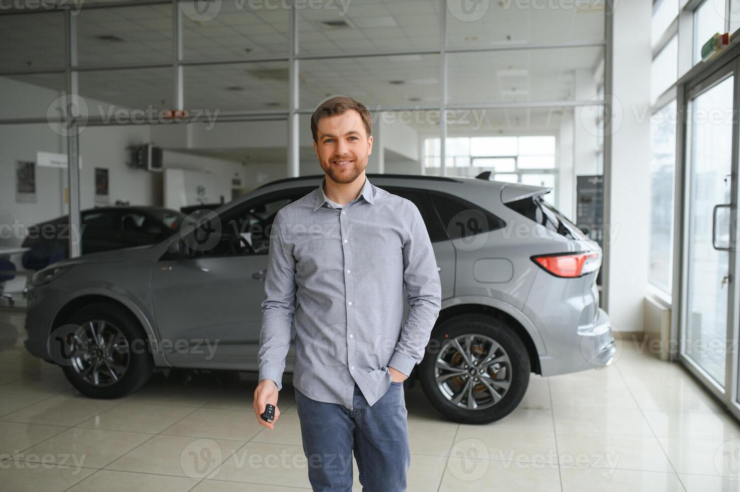 a man chooses a new car for himself walks between the rows in a car dealership photo