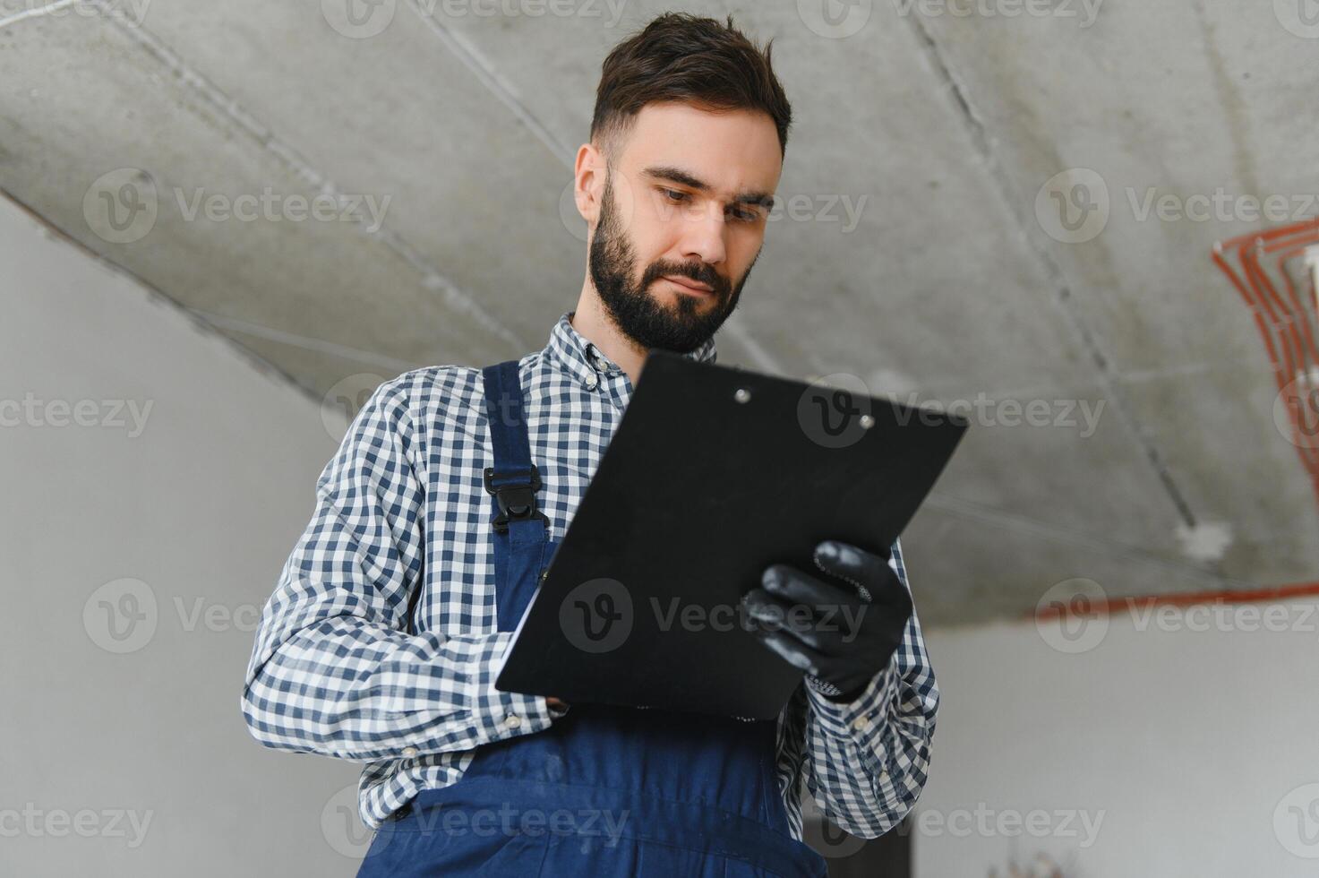 A dedicated worker doing calculations for material for apartment in construction process. photo