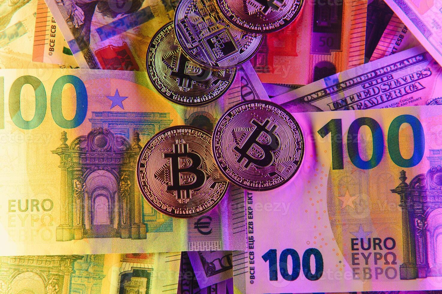 golden bitcoins new virtual currency with traditional dollars and euro as a background photo