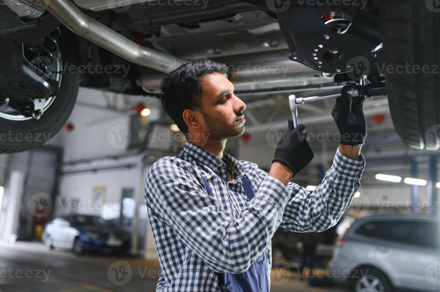 Handsome Indian Auto Mechanic at car servise photo