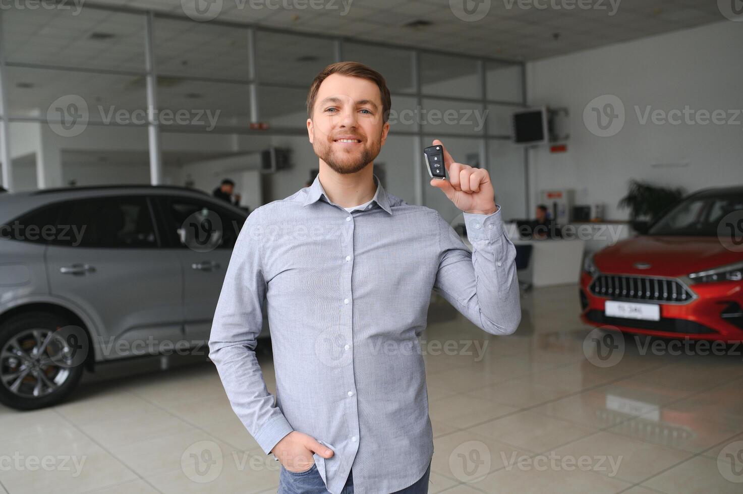 joven hombre es elegir un nuevo vehículo en coche concesión. foto