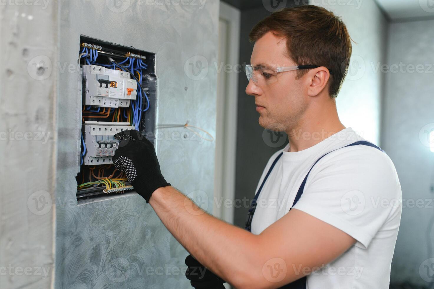 Portrait of an electrician at work photo