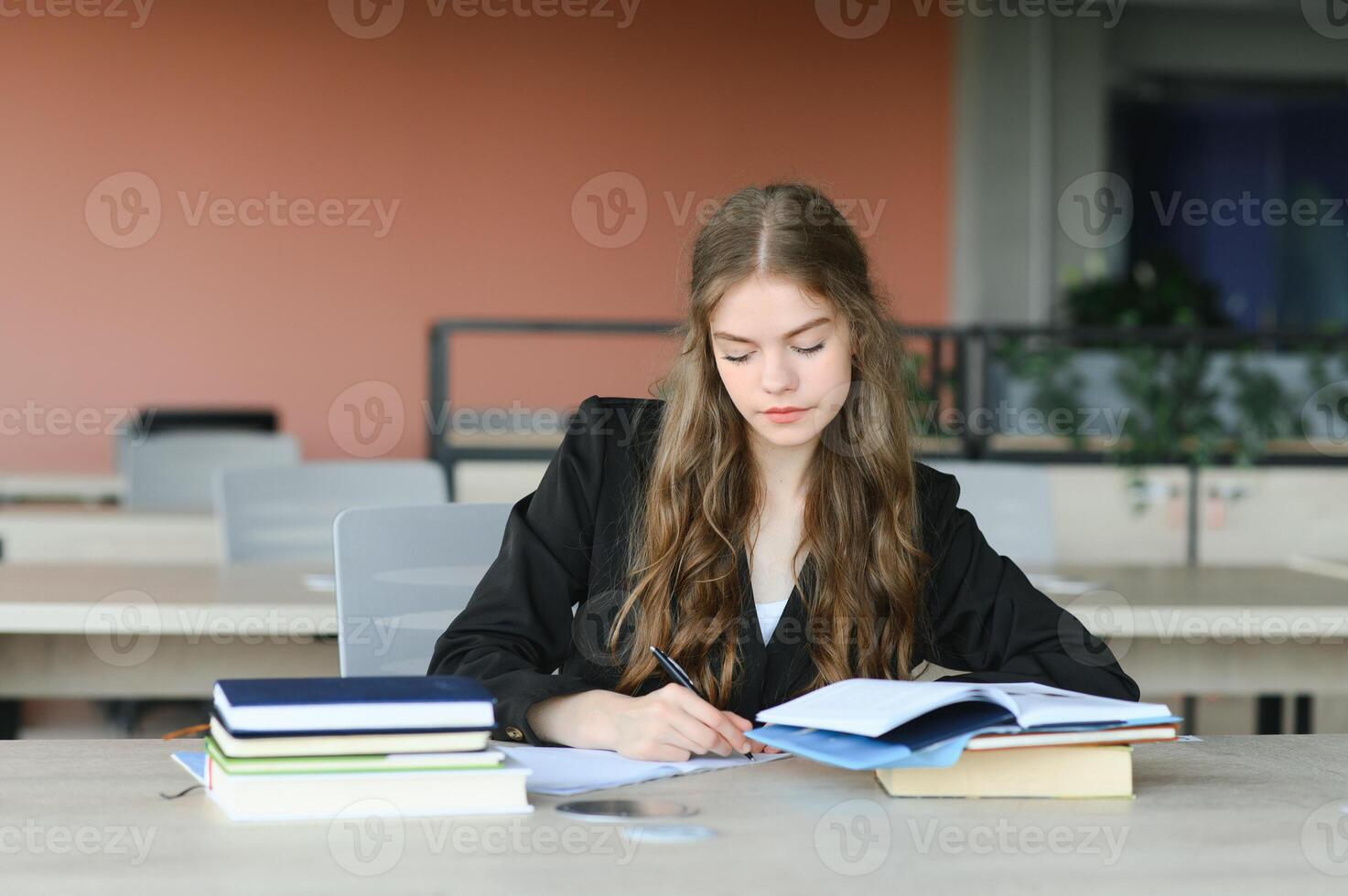 education and school concept - student girl studying and reading book at school. photo