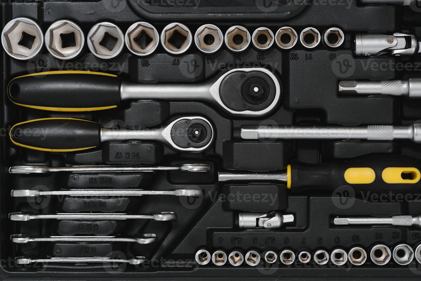 New square black tool box on wooden texture background. Top view. photo