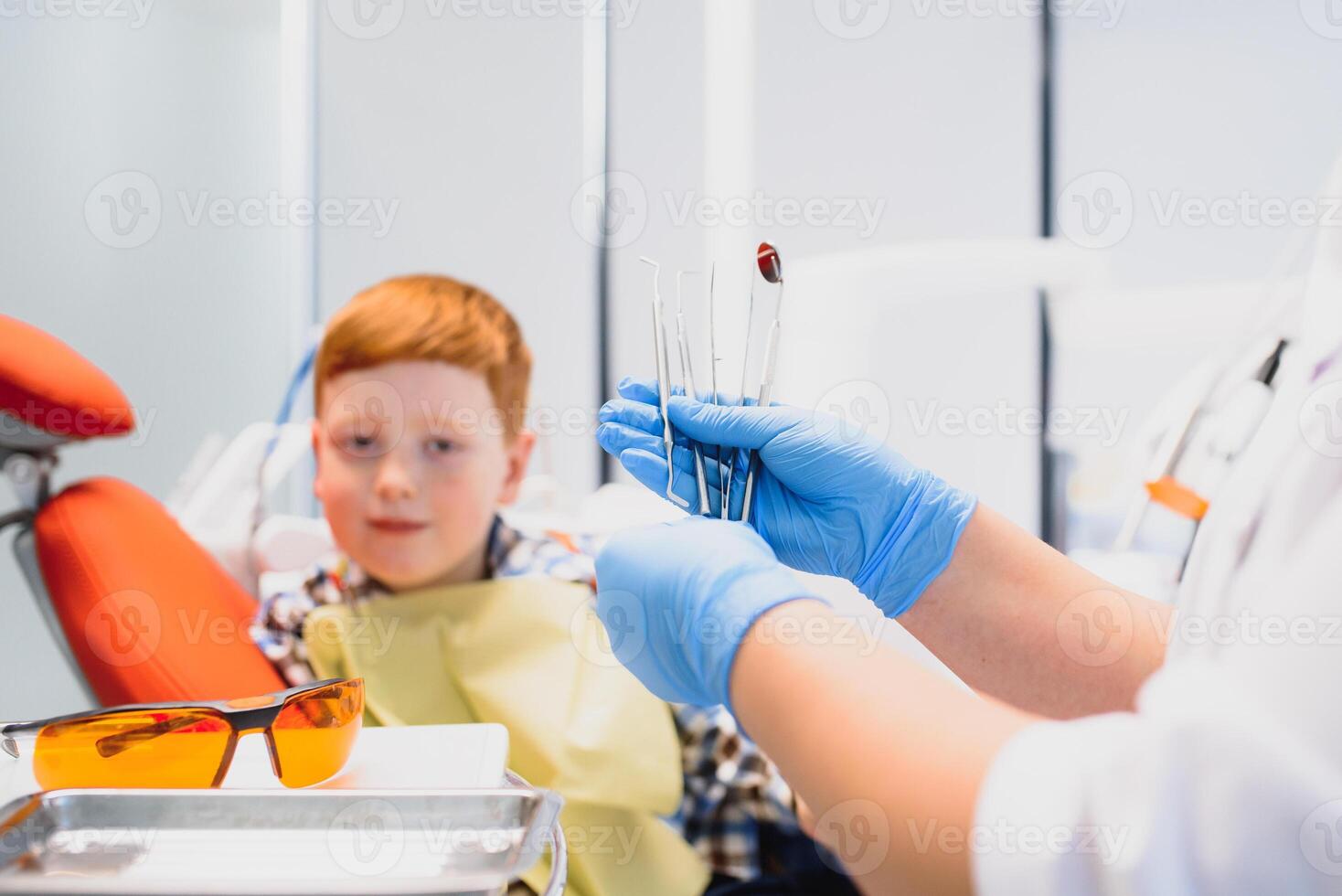 Female dentist and child in a dentist office photo