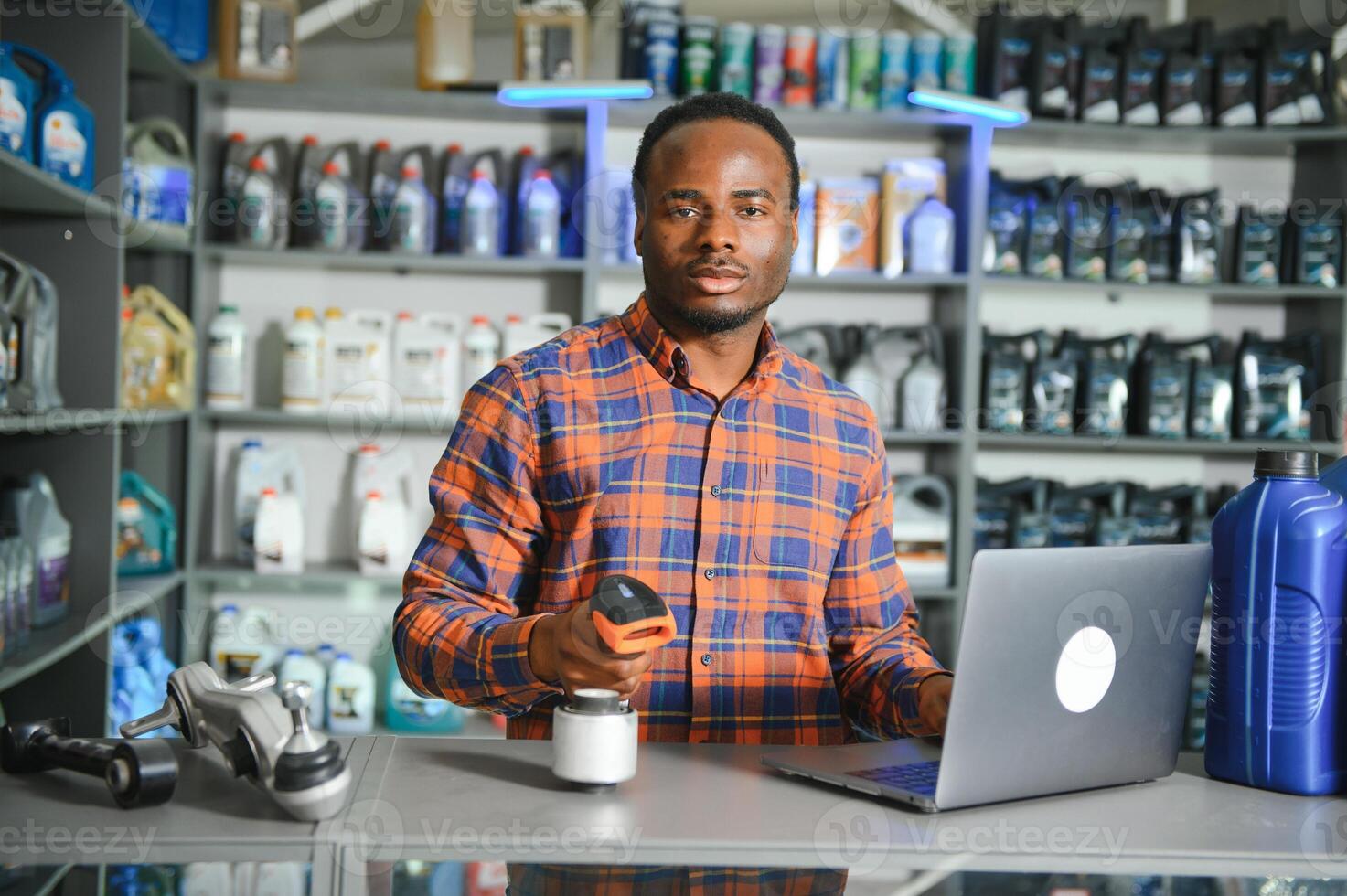 Portrait of a handsome african salesman in an auto parts store. The concept of car repair photo