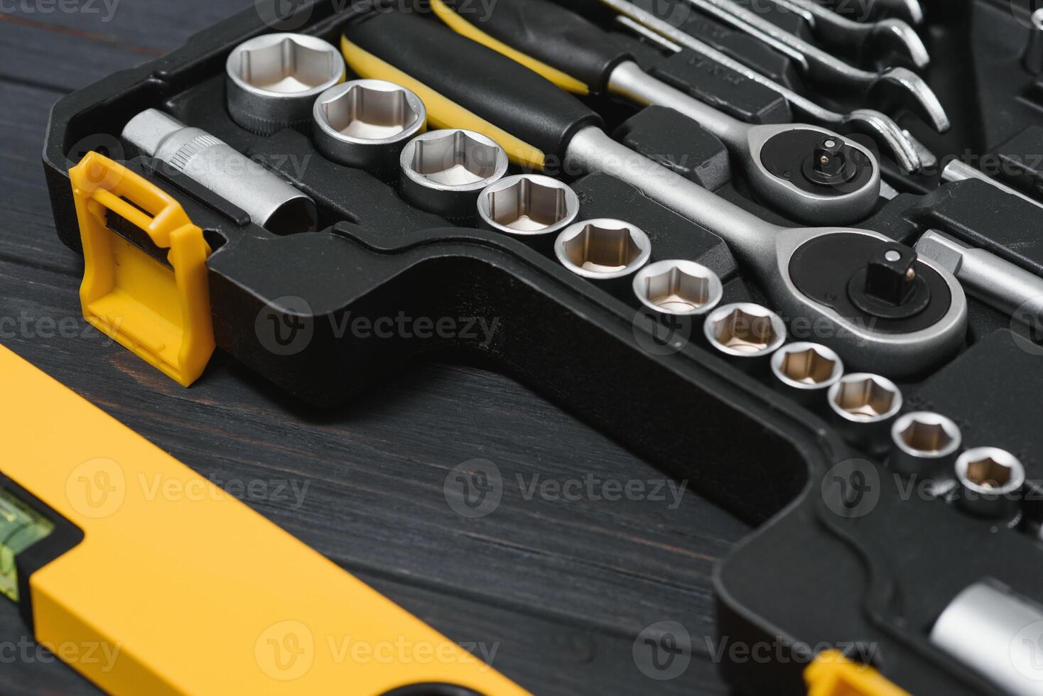 New square black tool box on wooden texture background. Top view. photo