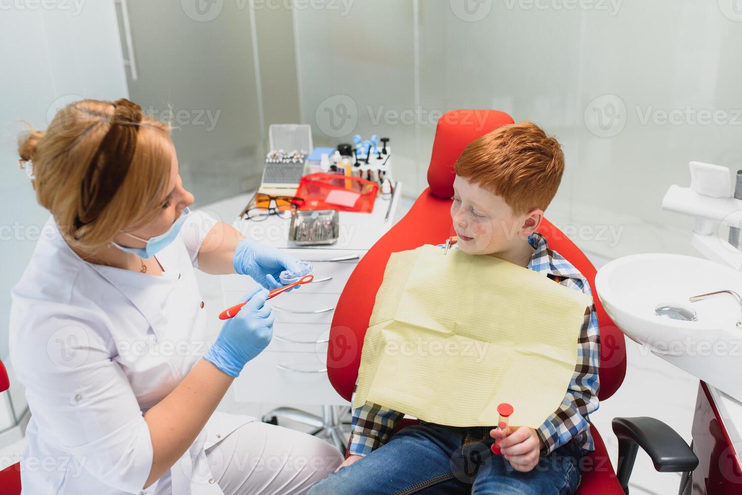 Female dentist and child in a dentist office photo