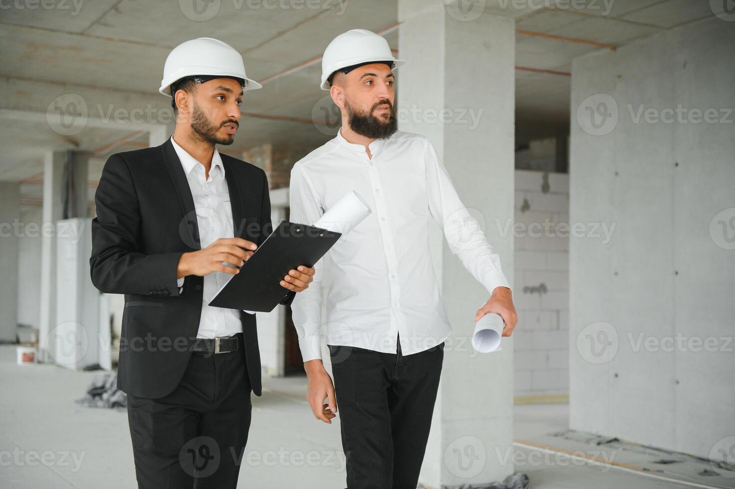 Construction concept of multiracial Engineer and Architect working at Construction Site with blue print photo