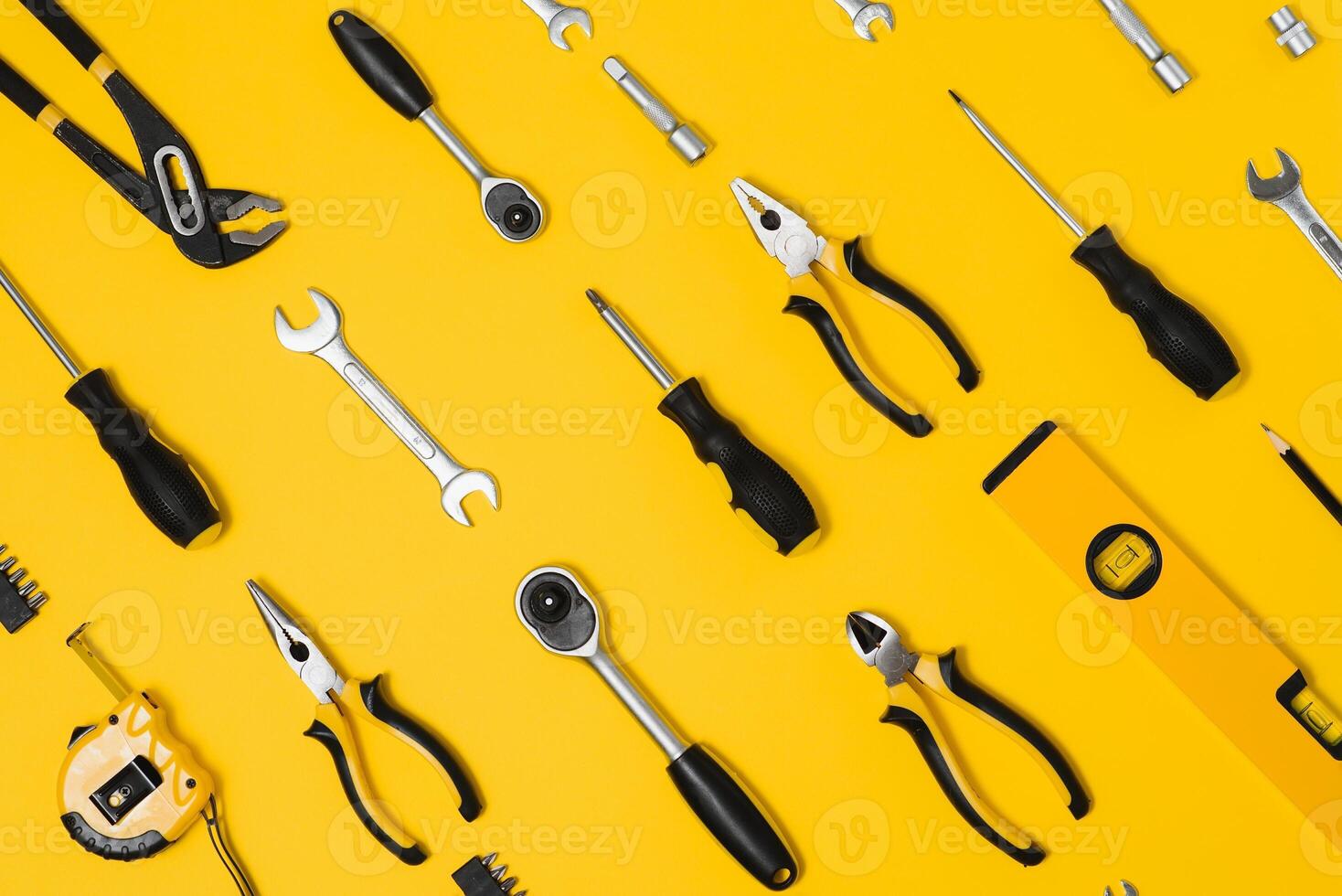 Set of various construction tools. Tools for home repair. Work at a construction site. On a yellow background. Flatly. Flatlay photo