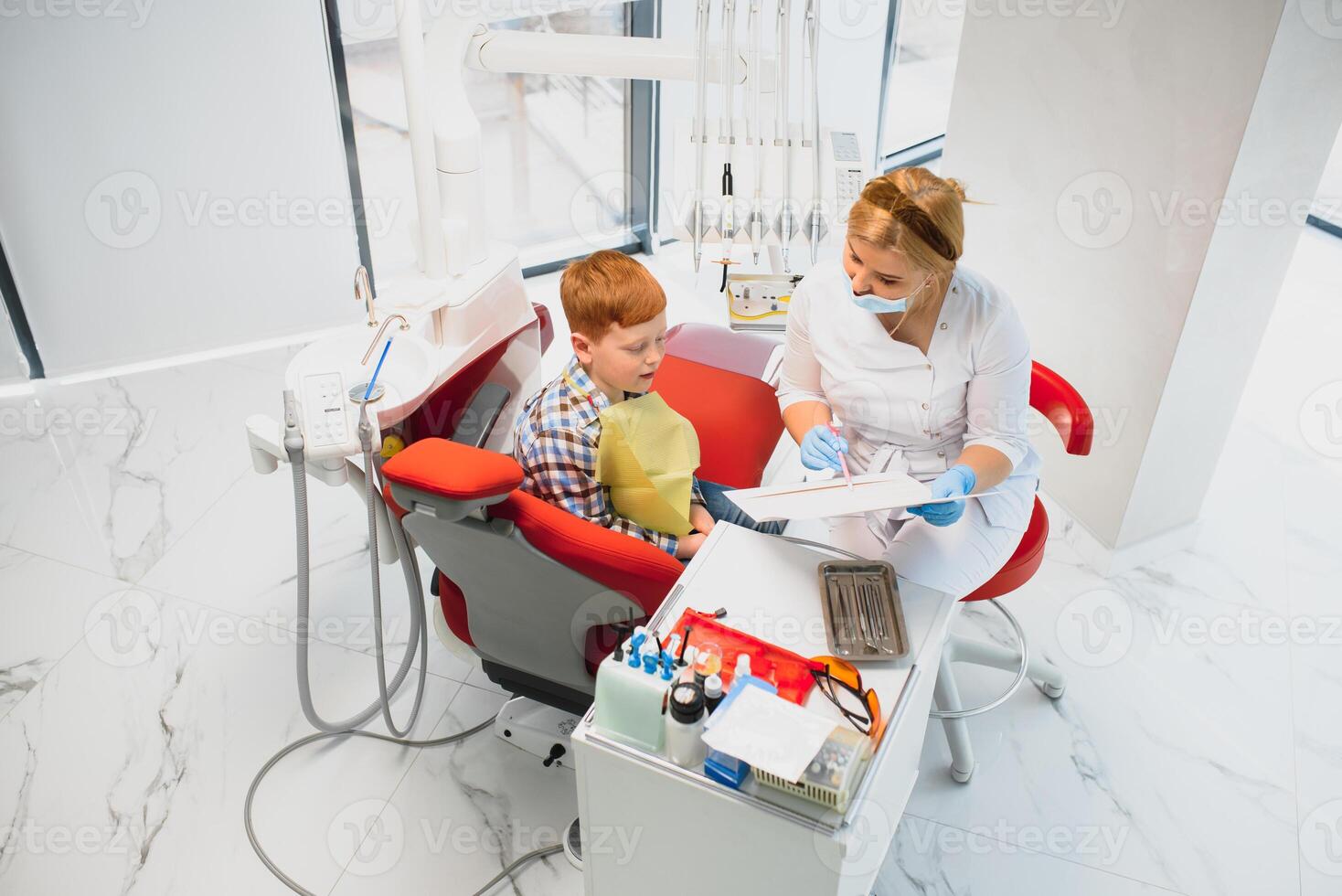 Boy satisfied with the service in the dental office. concept of pediatric dental treatment photo
