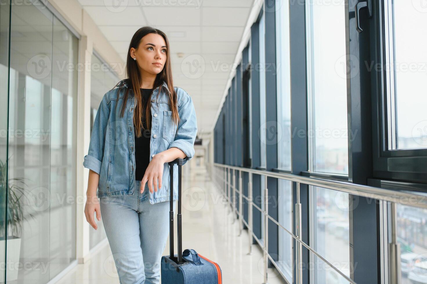 pretty woman waiting for her flight at airport photo