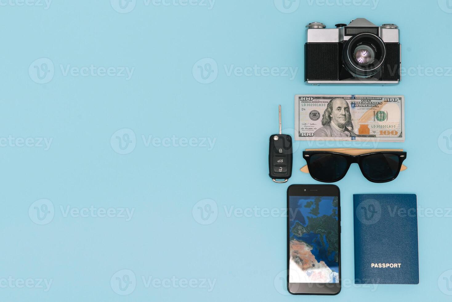 Preparation for Traveling concept, watch, airplane, money, passport, pencils, book, Photo frame, eyeglass on blue background with copy space.