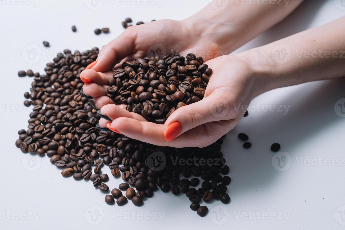 Coffee beans in woman's hands. photo