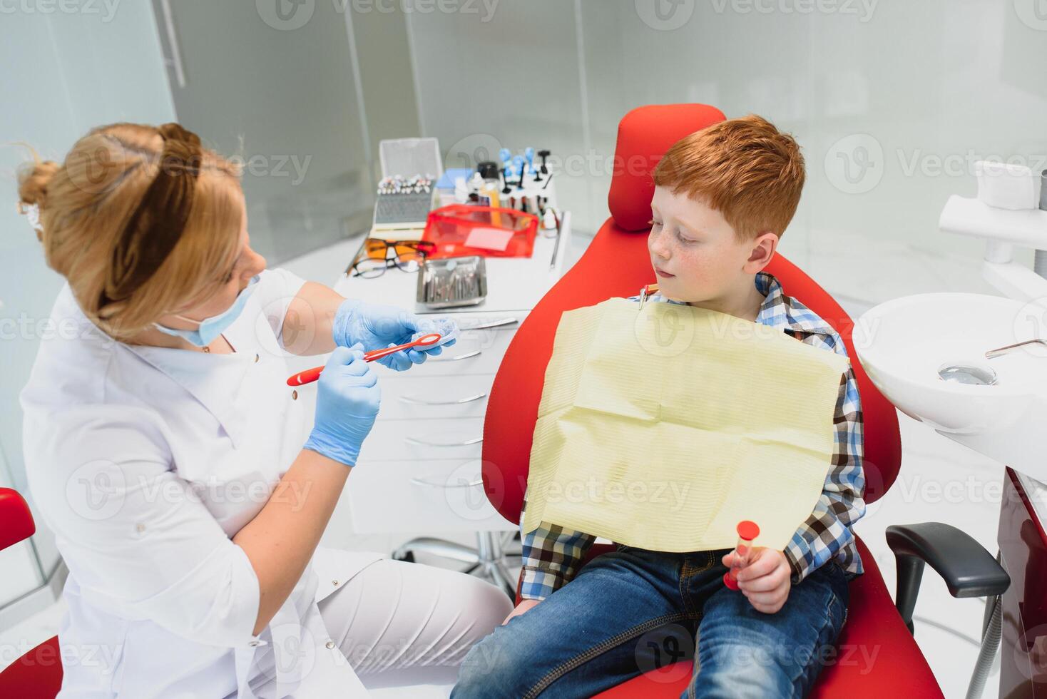 Boy satisfied with the service in the dental office. concept of pediatric dental treatment photo