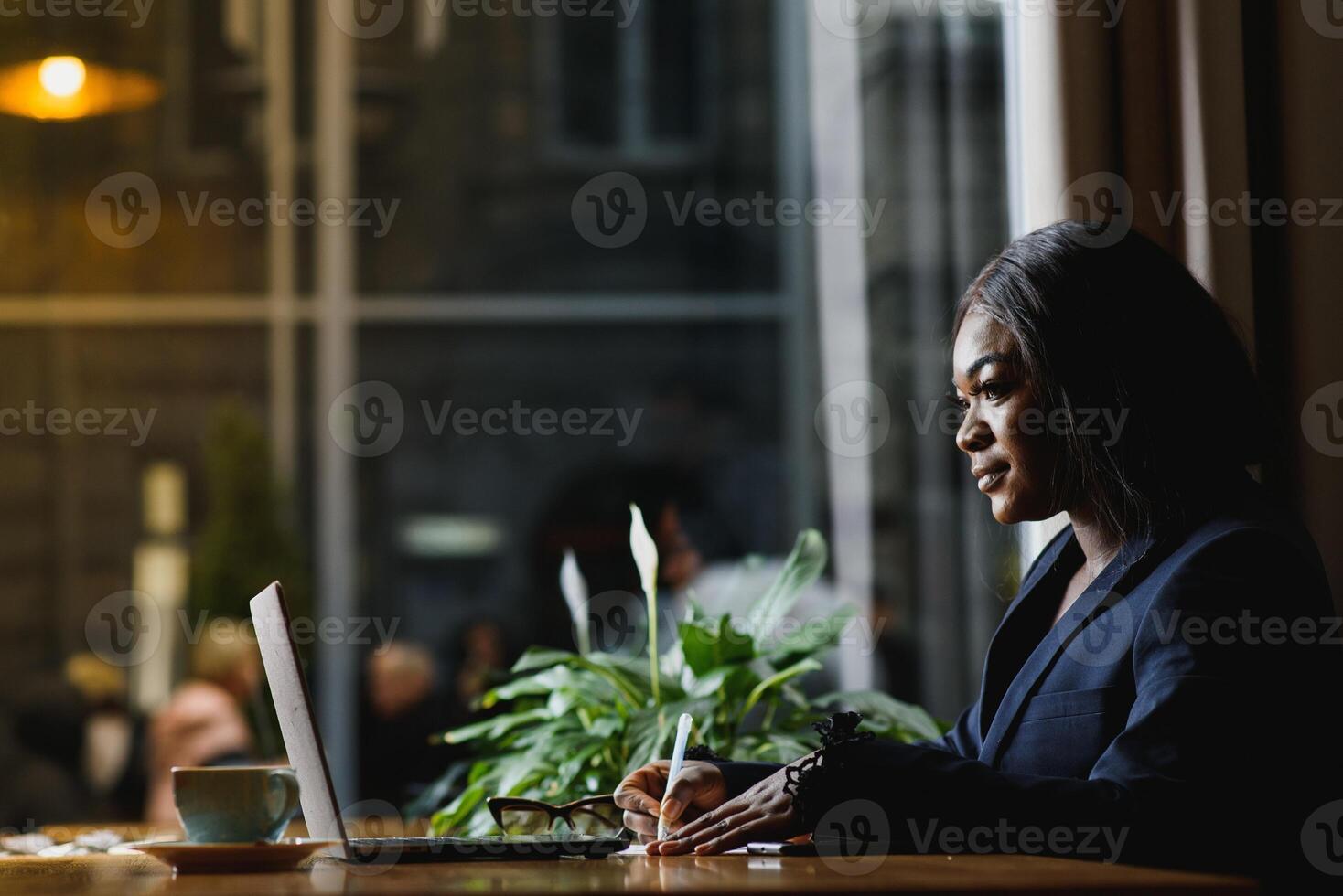 happy young african american businesswoman using computer in office photo
